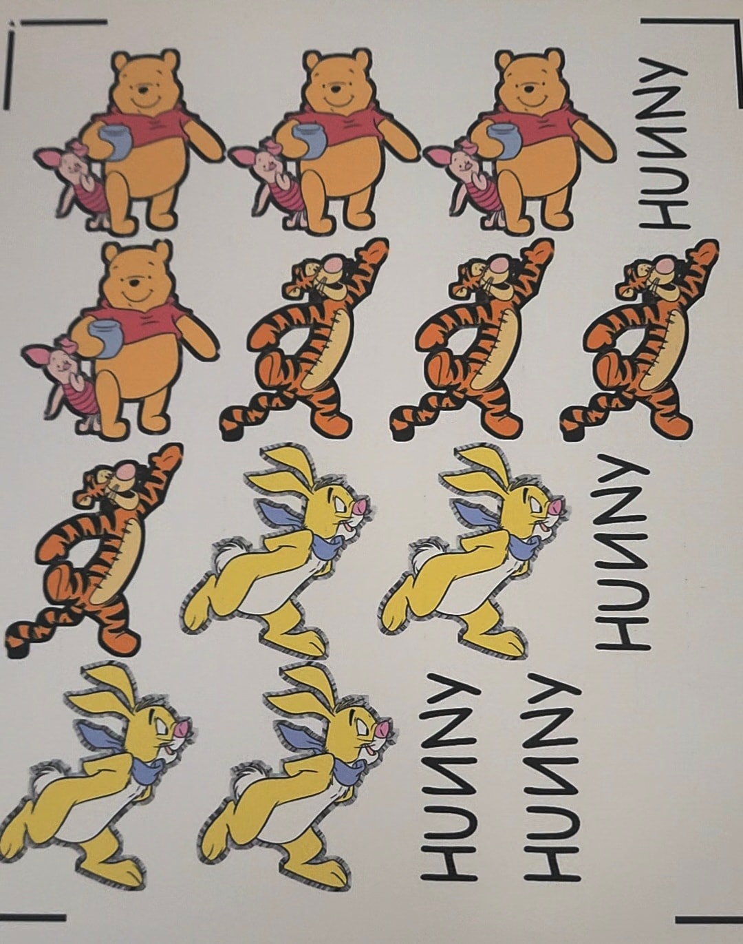 Sheet of customized edible images featuring Winnie the Pooh, Tigger, Rabbit, and Piglet characters with Hunny text cutouts